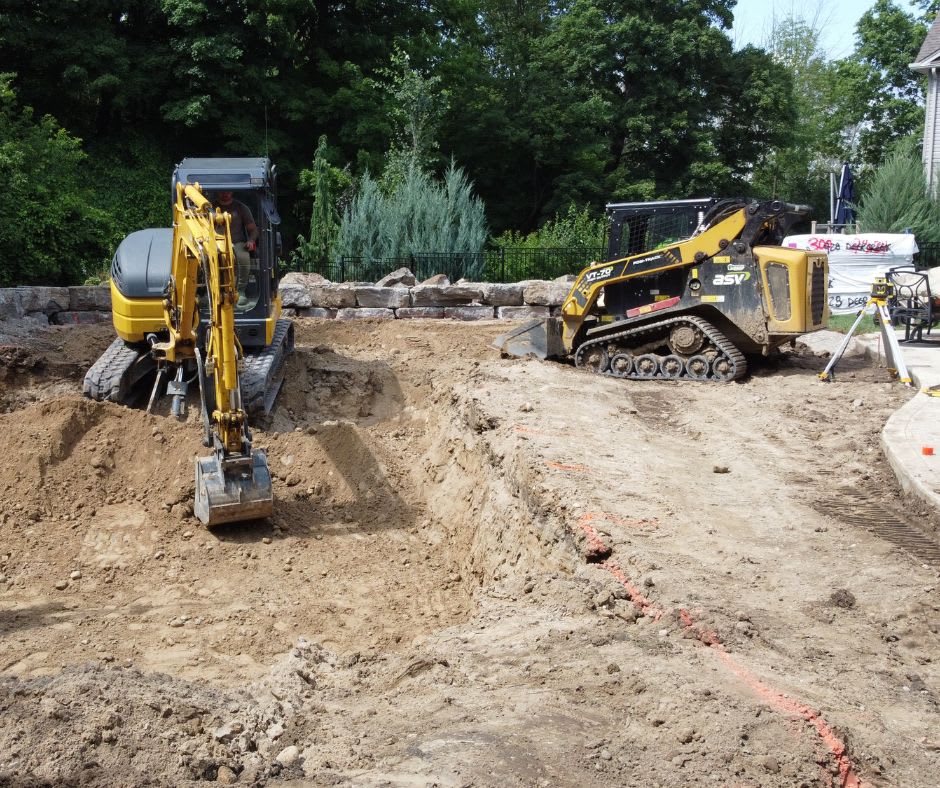 Mini excavator and compact track loader working together